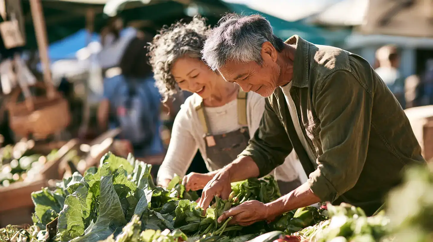A small group of friends in their sixties and seventies, mixed races and both genders, turning a good ear toward a friend across a noisy cafe table