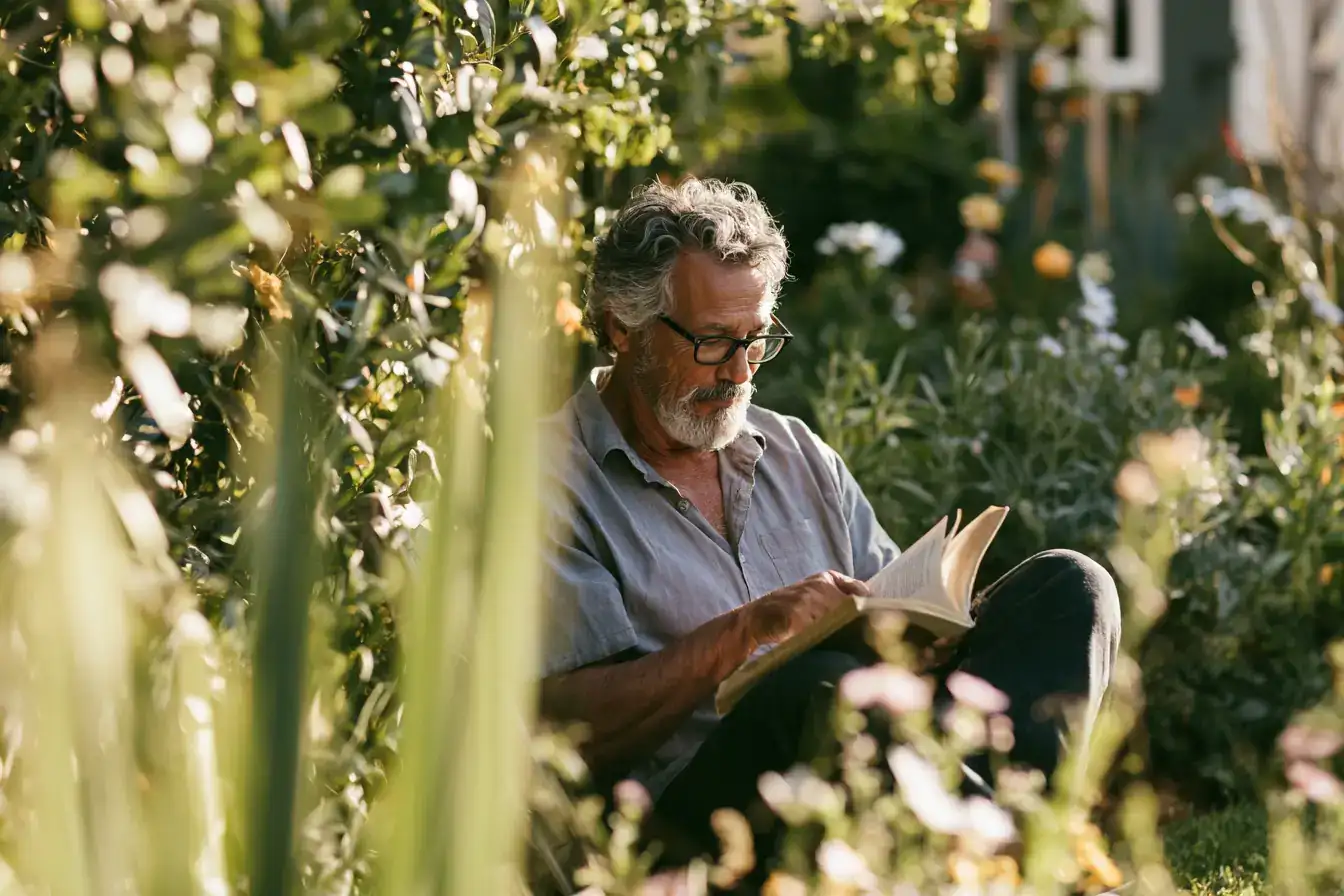 A Latino man in his seventies with headphones on, eyes closed, listening