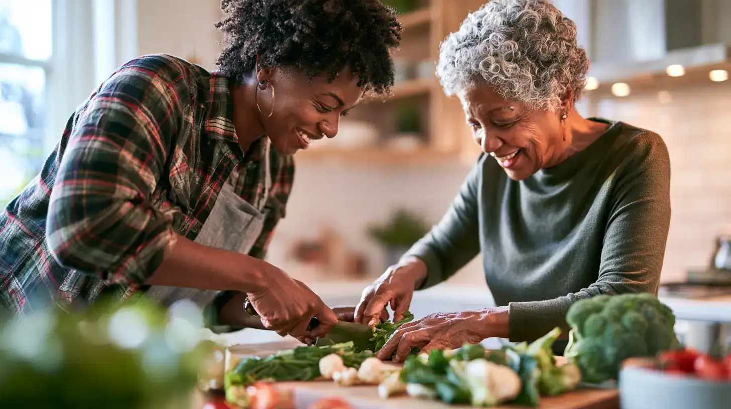 A Black woman in her fifties and her mother in her late seventies showing a screen to a daughter across the table
