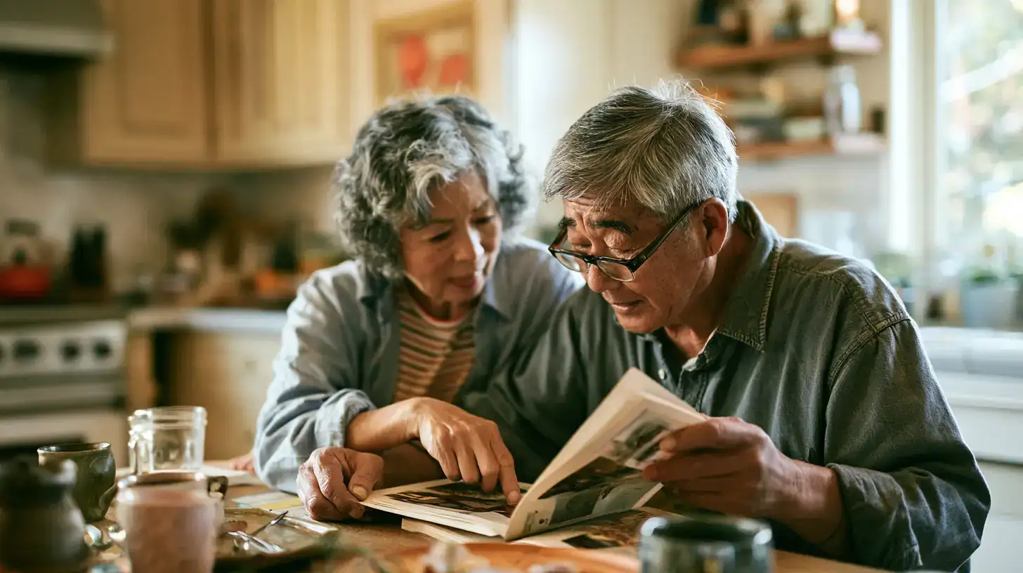 A small group of friends in their sixties and seventies, mixed races and both genders, tilting a head to follow a story at a long outdoor table